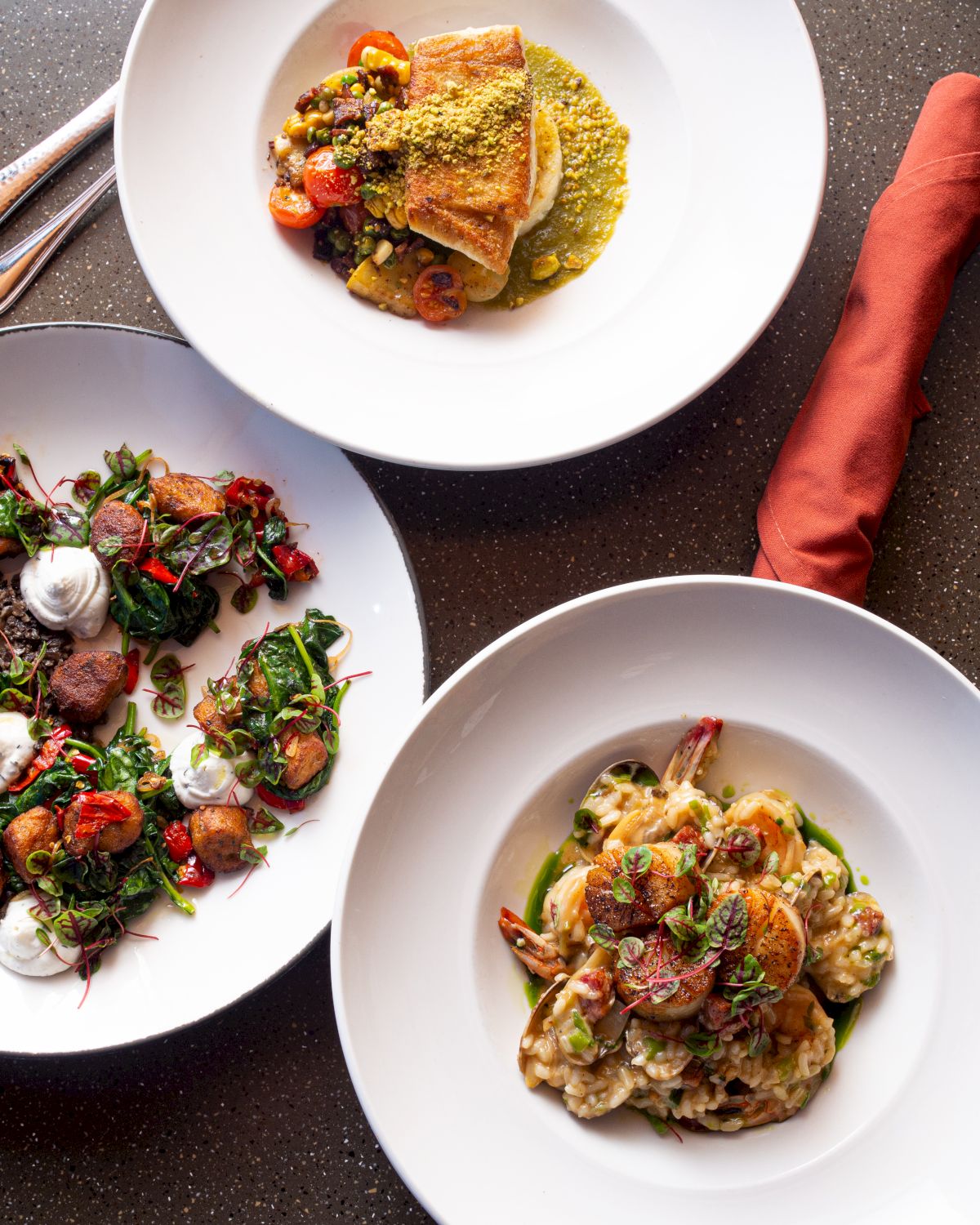 Three plated dishes: a cauliflower/veg curry with crusty bread, a colorful salad with greens and figs, and a creamy pasta with vegetables, all artfully arranged.