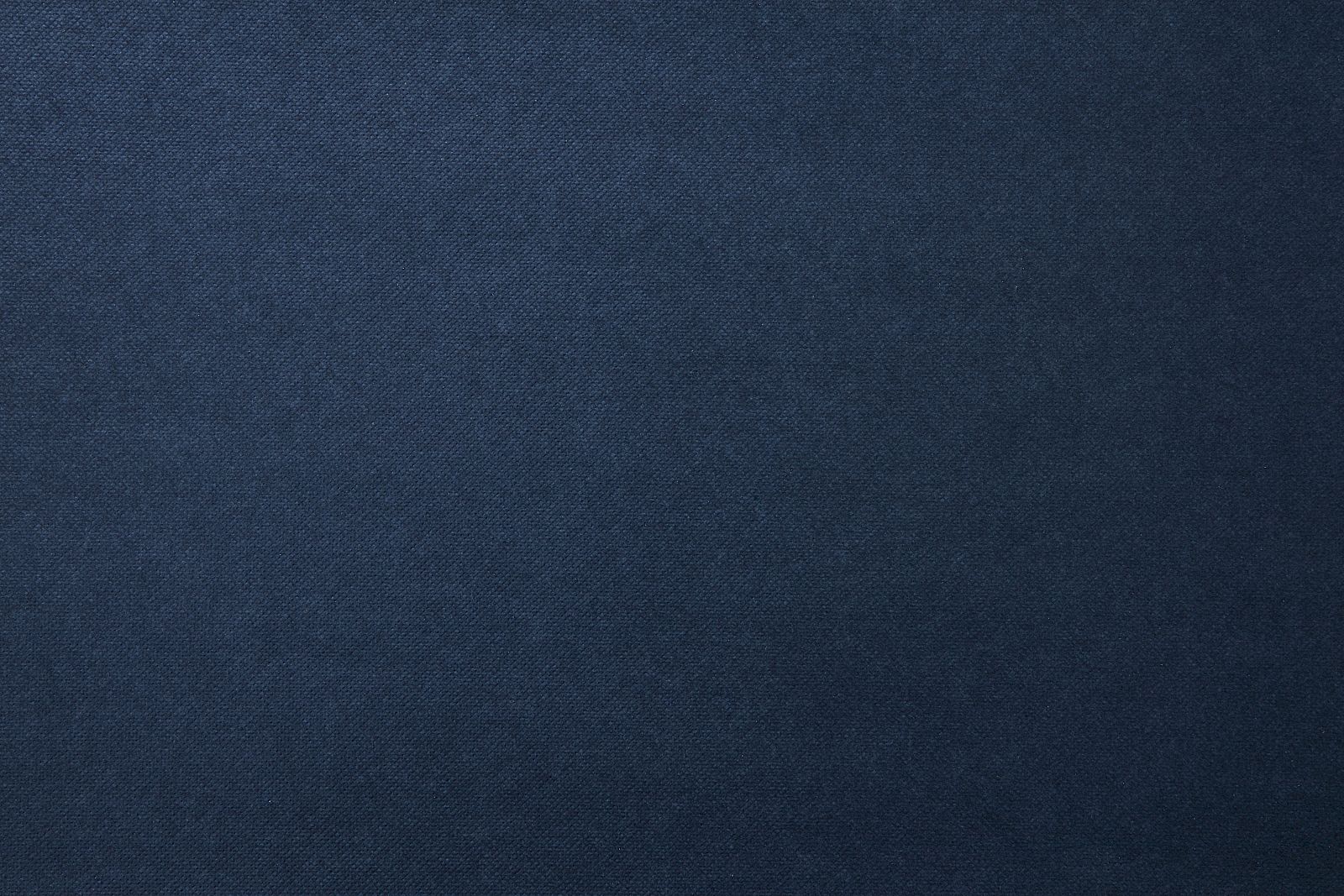 The image shows a textured dark blue fabric surface with a subtle grainy appearance, consistent throughout the entire frame.