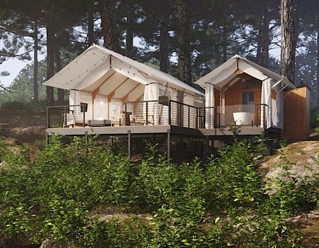 Modern glamping tents on a raised deck in a forest, with warm lights and wooden cabins under white canvas roofs.
