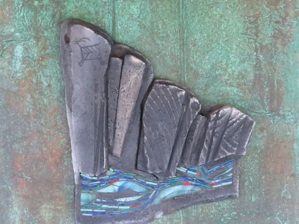 The image shows a textured artwork featuring abstract shapes over a green background, possibly resembling rocks and water.