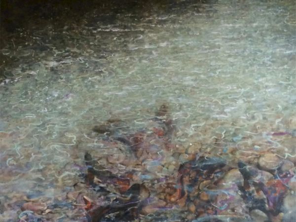 The image depicts a serene water surface with gentle ripples and rocks visible underneath, creating a calm and peaceful atmosphere.