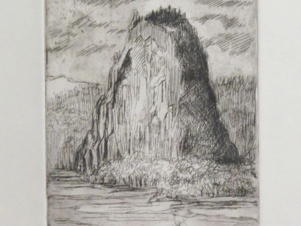 The image shows an etching of a steep rock formation surrounded by water, with clouds above. The style is detailed and monochromatic.