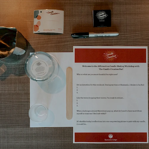 The image features a water pitcher, glass, pen, notepad, and a sheet with text on a table, seemingly set up for a meeting or conference.